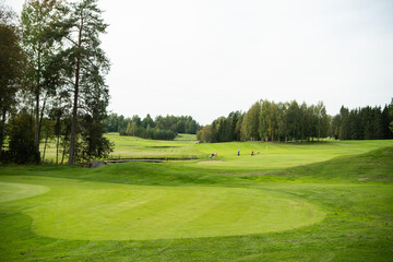 Fototapeta premium Golf course with people in the background 