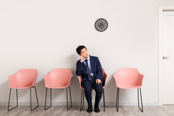 Asian applicant waiting for job interview in room