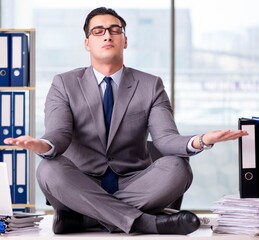 Businessman meditating in the office