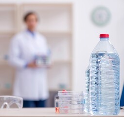 Young male chemist experimenting in lab