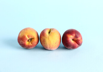 Sweet peaches on blue background