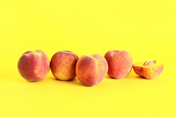 Sweet peaches on yellow background