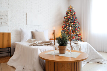 Interior of festive bedroom with Christmas tree