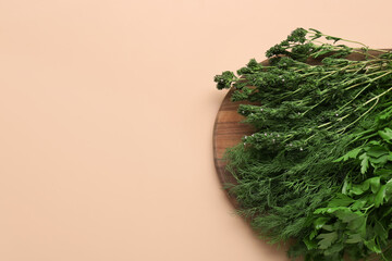 Wooden board with different fresh herbs on color background