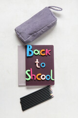 Text BACK TO SCHOOL and stationery on light background