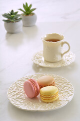 Pastel macaroons with tea