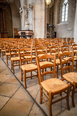 Empty chairs inside the cathedral of Dijon, France, forming a pattern
