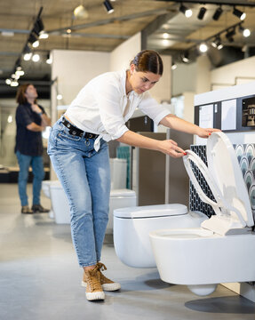 Woman looking to buy new toilet in harware store