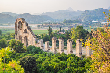 Fototapeta na wymiar Aspendos Ancient City. Aspendos acropolis city ruins, cisterns, aqueducts and old temple. Aspendos Antalya Turkey. turkiye