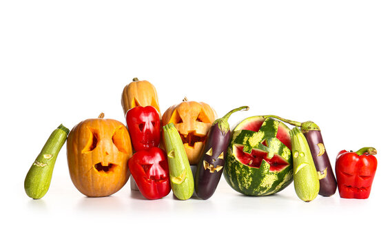 Carved watermelon, eggplants, zucchini, pumpkins and bell peppers for Halloween on white background