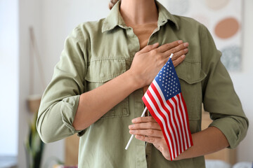 Young woman with USA flag at home, closeup. Veterans Day celebration