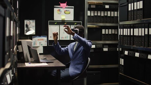 African american private detective investigates a questionable case, gathering clues and evidence using modern technology. Police officer utilizing virtual reality glasses to analyze criminal records.