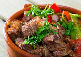Image of tasty gyuvech dish of bulgarian cuisine with beef and vegetables at clay pot