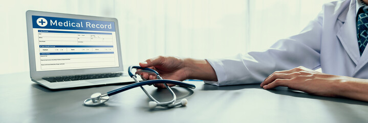 Doctor carefully review detailed medical report on laptop and diagnosing illness for effective...
