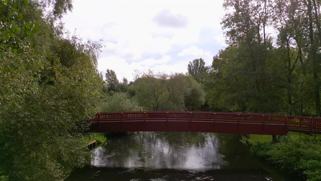 Aerial view of red bridge over riverlike stream in Odense, Funen, Denmark