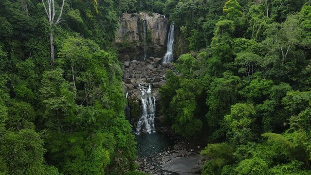 Drone shot of the famous Nauyaca Waterfall in Costa Rica. Misty day in the Central American tropical rainforest.