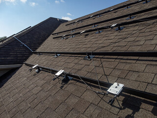 Racks and power optimizers for installing photovoltaic system on residential home roof