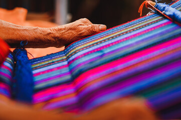 Close up shot of Guatemalan handcraft textile and colorful patterns made by indigenous woman
