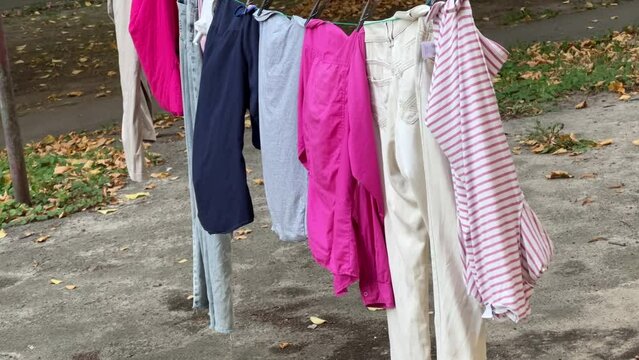 Bright clothes and underclothes are dried on ropes outside
