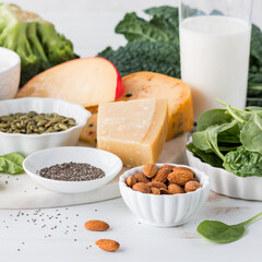 An assortment of calcium rich foods including greens and dairy.