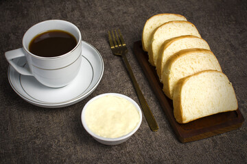 Homemade sponge cake or chiffon cake in a wooden container, soft and moist dessert with tea. Homemade bakery concept for background.