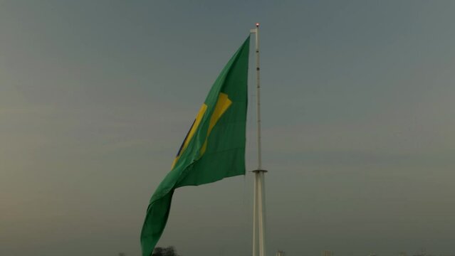 Brazilian flag, in the wind, seen from a drone.