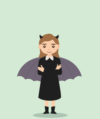 girl using bat costume and devil horns at halloween party