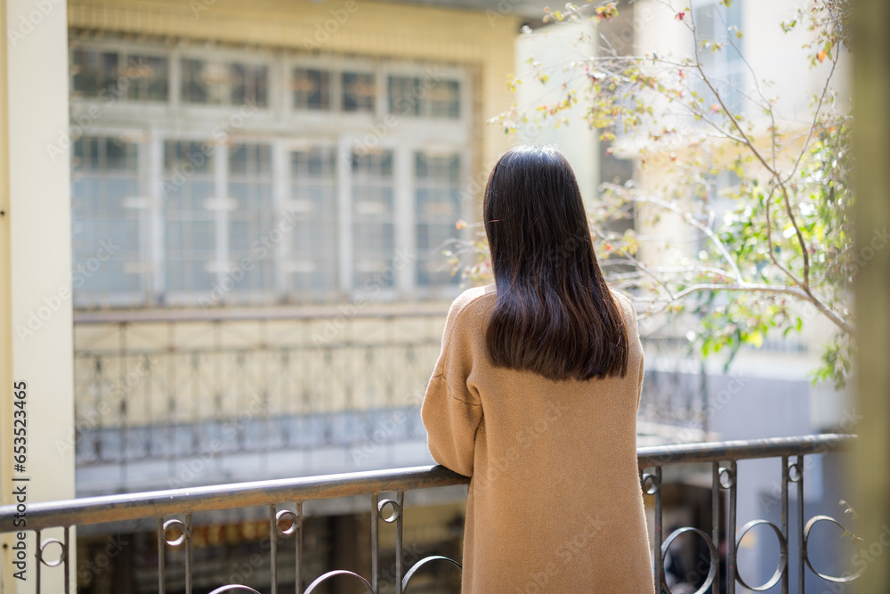 Wall mural Woman enjoy look at the view outside the balcony