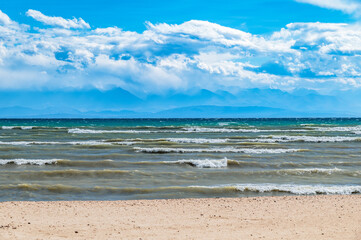 Fototapeta na wymiar Thunderclouds over Issyk-Kul. Beautiful waves on the lake.