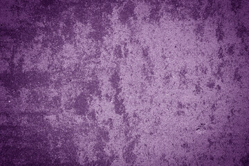 Grungy cement wall texture in purple color.