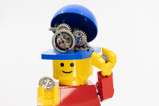 Hong Kong - September 28 2023: small worker fix the gear wheels in the head of giant man