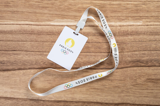 ZHONGSHAN China-September 25 2023:Paris Olympic Games 2024 IC card with strap on a wood background.