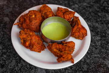 Indian chicken kebabs, marinated in spices and yoghurt and roasted in tandoor. served with green chutney. selective focus
