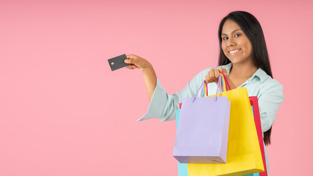 Woman with shopping bags and a credit card