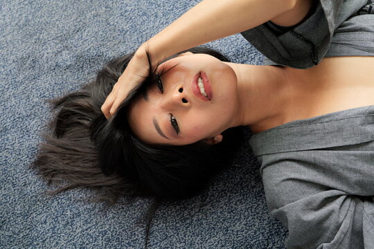 Portrait of young Asian woman lying on the floor