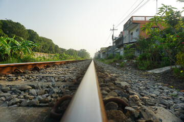 Railroad tracks behind residential areas.