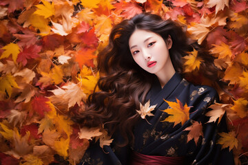 Naklejka na ściany i meble Japanese fashion model woman face on autumn leafs, long hair