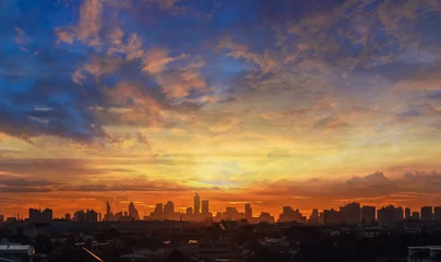Foto op Canvas Background of orange sky with clouds and sunset in city. © chaphot