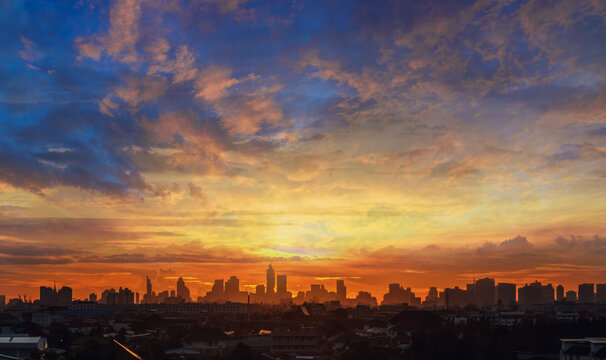 Background Of Orange Sky With Clouds And Sunset In City.