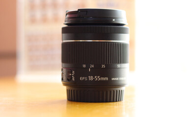 Fototapeta na wymiar DSLR camera lens - digital camera lens 18-55 mm zoom lens with blur background