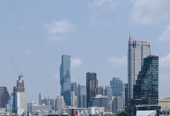 panorama landscape view of chaopraya river with river water boat transportation and background of bangkok city skyline with many highrise skyscraper among central district area in daytime