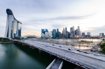 sunset view of singapore city down town central district skyline with highway bridge and many skyscraper business  buildings at marina bay area in summer time. Sinngapore city
