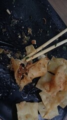 Noodle and dimsum served on black plate with chopstick, spicy food