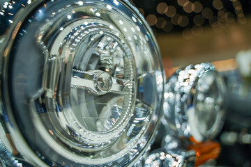 Closeup motorbike headlight of Chopper with clear and chrome colors