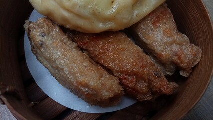 Dimsum is a unique food from Hong Kong which contains shrimp, fish or meat. which is served on a wooden bowl 