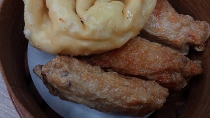 Dimsum is a unique food from Hong Kong which contains shrimp, fish or meat. which is served on a wooden bowl 
