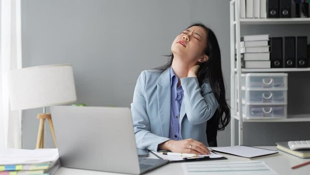 Attractive Asian business woman Relax from work after sitting for a long time. in order not to exceed the office syndrome at the office