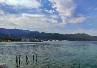 Limenas City in Thassos Island , Greece , with the mountains behind seen from the shore of the Aegean sea