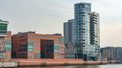 Obraz premium Hamburg, Germany - Hafencity, living and industrial modern houses in harbor during warm sunset