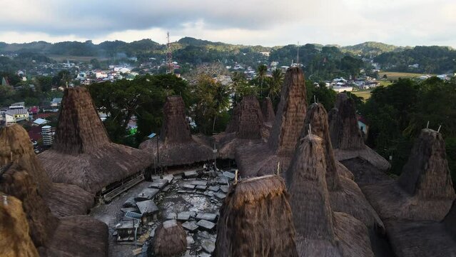 Sumbanese Traditional Straw-thatched Houses Over Mountains Near Rural Town In Sumba Island, Indonesia. Aerial Shot